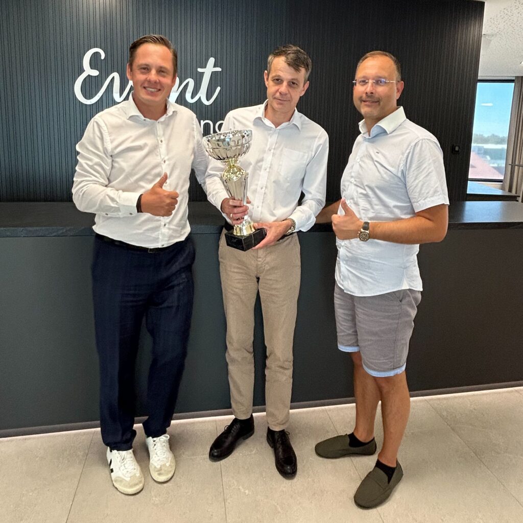 Gerald Frühauf with a trophy in his hand, Michael Kottnig on the left and Michael Kaiserseder on the right